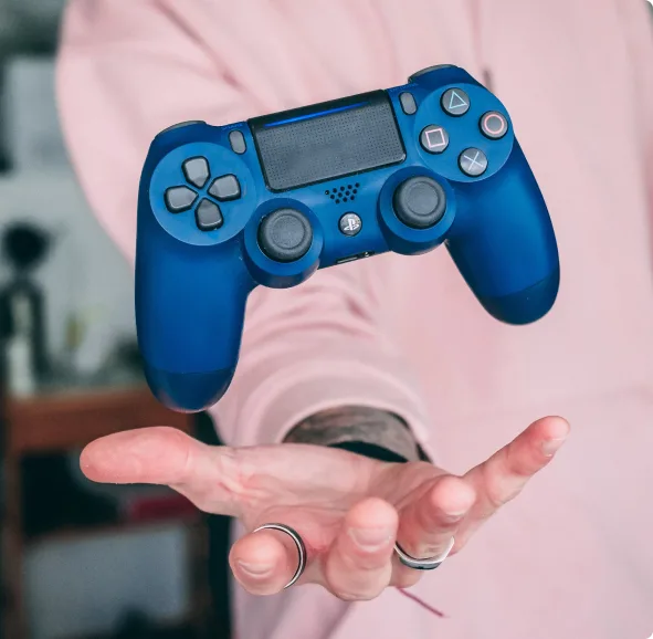 person throwing controller in air with one hand